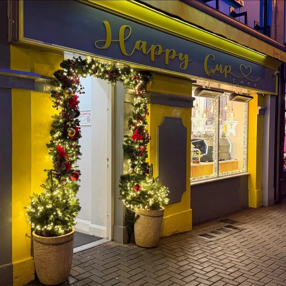 The yellow shopfront of The Happy Cup Cafe